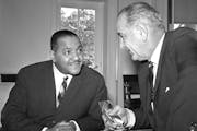 Carl Rowan, then ambassador to Finland, spoke with President Lyndon B. Johnson at the White House on Jan. 21, 1964.