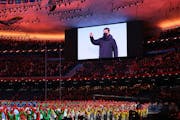 Chinese President Xi Jinping waved on the screen as dancers performed during the Opening Ceremony of the Beijing Winter Olympics. 
