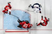 United States’ Hilary Knight (21) scores one of her two goals against Switzerland goalkeeper Saskia Maurer in an 8-0 win. 