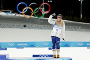 Bronze medallist Jessie Diggins of Afton, Minn., celebrates on the podium during the Women’s Cross-Country Sprint Free Final medal ceremony.
