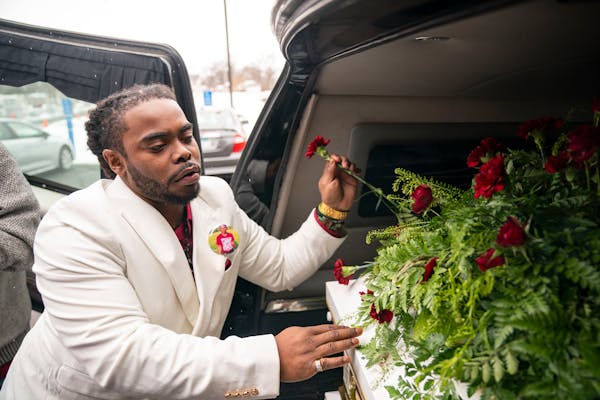 Cortez Rice, Jahmari Rice’s father, handed out roses and flowers from his son’s casket to other family members after his funeral Wednesday at Hope