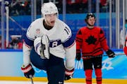 United States’ Kenny Agostino celebrates after scoring a goal against Canada during a preliminary round men’s hockey game at the 2022 Winter Olymp