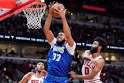Timberwolves center Karl-Anthony Towns (32) grabs a rebound against the Bulls.