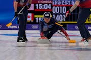 United States’ John Shuster throws a rock during a men’s curling match against Canada at the Beijing Winter Olympics on Sunday