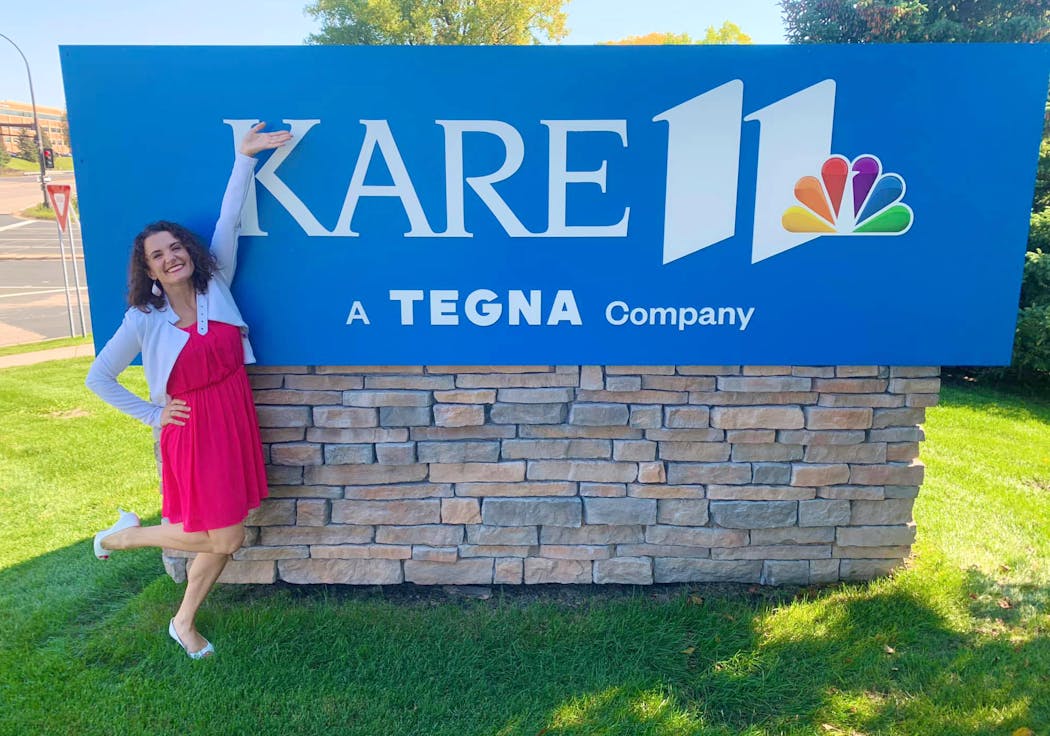 Reporter Eva Andersen poses in front of the KARE 11 sign on her first day on the job in the fall of 2021.