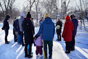 Neighbors including Mary Gitschier McCarthy, with flowers, held a memorial service Sunday for a man who was found dead in a south Minneapolis storm dr