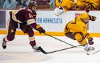 Gophers forward Rhett Pitlick, right, battled Minnesota Duluth’s Luke Loheit for the puck in October. Pitlick has three goals and four assists in hi