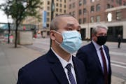 Former Minneapolis police officer Tou Thao arrives with his attorney Robert Paule for a Sept. 11, 2020, hearing at the Hennepin County Family Justice 
