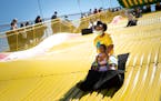 Shawnda Henderson of Minneapolis rode the Giant Slide with her daughter Mira on the last day of the “Kickoff to Summer” event at the Minnesota Sta