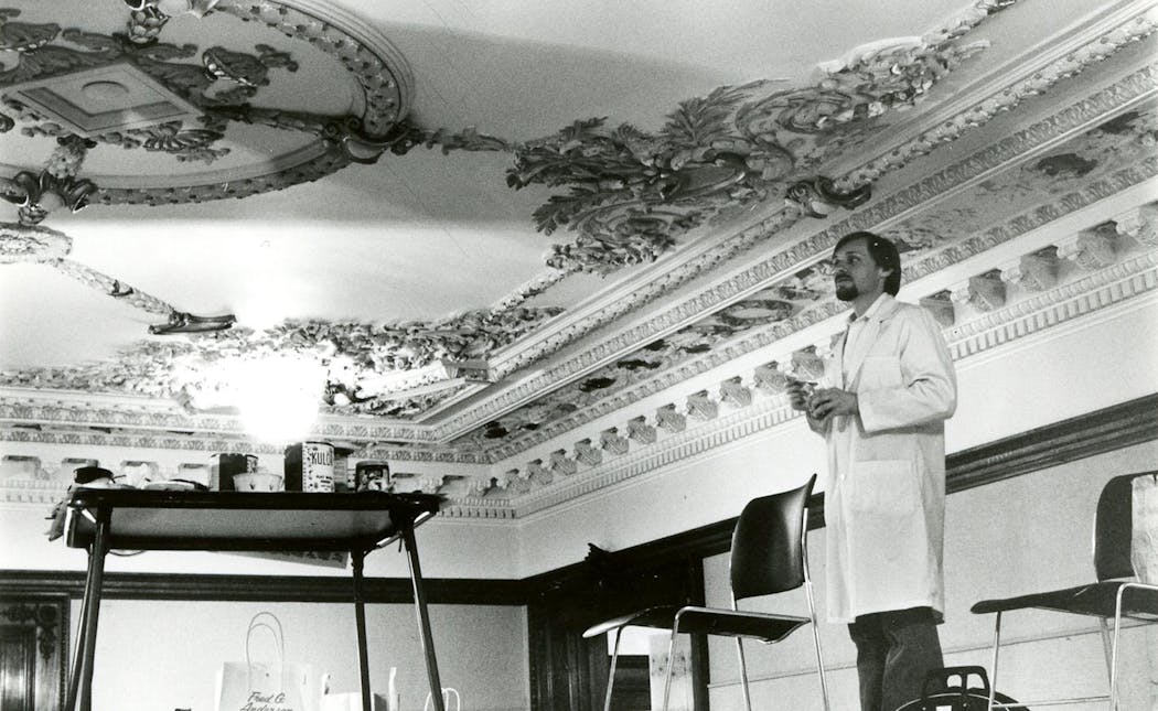 Curt Pederson works to restore the ceiling of the Turnblad Mansion’s Grand Hall in 1981.