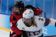 Canada’s Marie-Philip Poulin collides United States’ Lee Stecklein during the women’s gold medal hockey game. Poulin, the team captain, scored t
