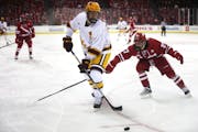Minnesota defenseman Jackson Lacombe (2), above looking to pass vs. Wisconsin, got the game-winner against Penn State on Saturday.