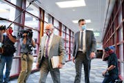 Former Minneapolis police officer Thomas Lane, right, entered the Hennepin County Public Safety Facility with his attorney Earl Gray, left, during a p