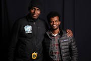 Mohamed Abdi Mohamed, right, stands for a portrait with his mentor Abdi Bile, the most decorated athlete in Somalia’s history. Bile, who directs a r