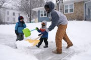 Ricky Bibuka got some help from his sons Kingston, 4, and Lachlan, 2, as he shoveled the sidewalk in front of their home Friday, Jan. 14, 2022, in nor