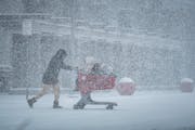 Shoppers braved the blowing snow heading to the Target parking lot on Tuesday, Feb. 22, 2022, in Apple Valley, Minn.