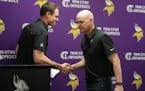 Kevin O’Connell shakes hands with defensive coordinator Ed Donatell as he introduced him during a press conference on Thursday at the Vikings traini