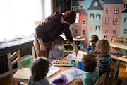 Dani Carlin helped children paint at Little Naturalists Preschool in January.