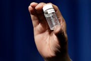 In this June 6, 2017, file photo, a reporter at a news conference about deaths from fentanyl exposure held an example of the amount of the drug that c