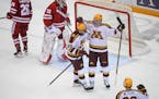 Gophers forward Matthew Knies (89) celebrated with Jaxon Nelson after a goal scored by Nelson in the second period against Wisconsin on Friday.