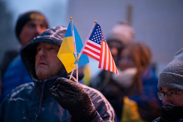 Julian Pishko held Ukrainian and American flags while attending an emergency rally to support Ukraine on Thursday evening at St. Constantine Ukrainian