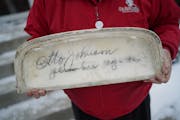 Homeowner Alan Peters turned over the signed toilet tank lid to plumber Otto Johnson’s descendant, granddaughter Lynda Bornhoeft, of Big Lake, Thurs