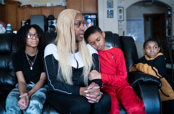 Michaelena Seals, who sat with her children Leaja Seals, 15, Adrian Walker III, 11, and Jeriah Witherspoon, 8, in their St. Paul home, has been anxiou