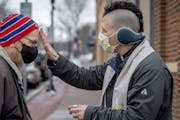 The Rev. Michael Le Buhn Jr. placed glitter ashes on Paul Wyatt of St. Paul on a Hastings street corner on Wednesday. The purpose of the glitter ashes