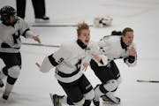 Minneapolis forwards John Bebler (9) and Ben Matthews (12) skated toward the student section to celebrate with their fans after Minneapolis defeated D
