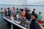 Members of the North Anglers Club from North High School and others prepared for a day on White Bear Lake. The club was created with a No Child Left I