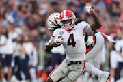 Georgia running back James Cook (4) carries the ball against Auburn during the second half of an NCAA college football game Saturday, Oct. 9, 2021, in
