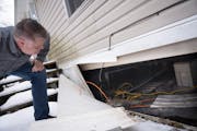 Rev. Dean Swanson checked under a home in the Viking Terrace Mobile Home Park that he and several other community members helped winterize as part of 