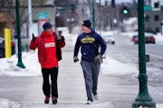 Phil Baebenroth, right, the new North St. Paul police chief, runs with North St. Paul Mayor Terry Furlong as Baebenroth began his weekly Friday commun