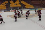 New Prague players leave the ice during their consolation game against the Minneapolis team in the state hockey tournament at 3M Arena at Mariucci Thu