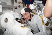 In this Aug. 17, 2021, photo made available by NASA, astronaut and Expedition 65 Flight Engineer Mark Vande Hei inspected a spacesuit in preparation f