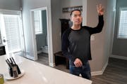 Army National Guard veteran JayDoo Vang, 30, gives a tour of the home he shares with three other vets, a north Minneapolis property developed for home