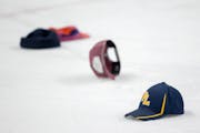 Caps were tossed onto the ice Thursday at the Minnesota state high school hockey tournament after a hat trick was scored.