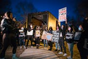 Organizer Anthea Yur gathered Asian American women in a circle and read their signs as they gathered on March 18, 2021, at Levin Park in Minneapolis i
