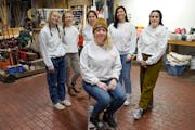 Rowland Paint owner and CEO Jessica Rowland, front center, with employees Hannah McNew, Haley Ryan, Katie Woodling, Mande Keir and Rachel Corradi.