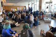More than 100 students hold a sit-in at the district office Thursday morning.