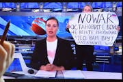 Marina Ovsyannikova, a dissenting Russian Channel One employee, holds up a poster condemning the Ukraine war during the evening newscast on March 15.