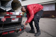 Independent driver Jamal Cotton made an impromptu repair to his trailer while filling up his tank in South St. Paul. The high diesel prices are making