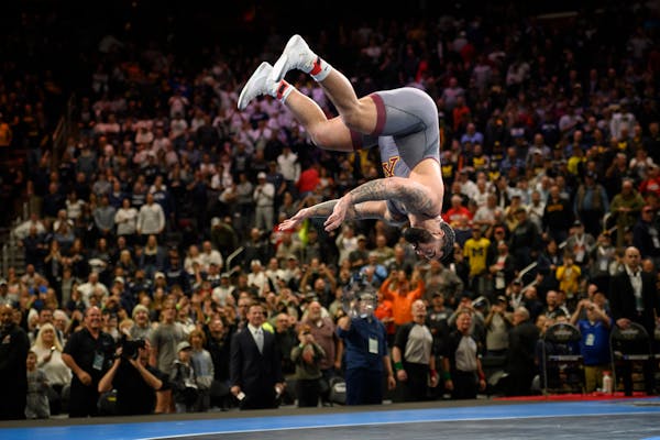 Minnesota’s Gable Steveson celebrates with a backflip after defeating Arizona State ‘s Cohlton Schultz during their heavyweight match in the final