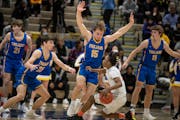 Wayzata’s Spencer Hall (23) and Drew Berkland (15) pressure Minneapolis South’s Jerome Williams Jr. in the Class 4A, Section 6 championship game o