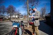 Pastor Travis Norvell heads home after an after-service gathering at Judson Memorial Baptist Church in Minneapolis on Sunday, March 20, 2022. Biking p