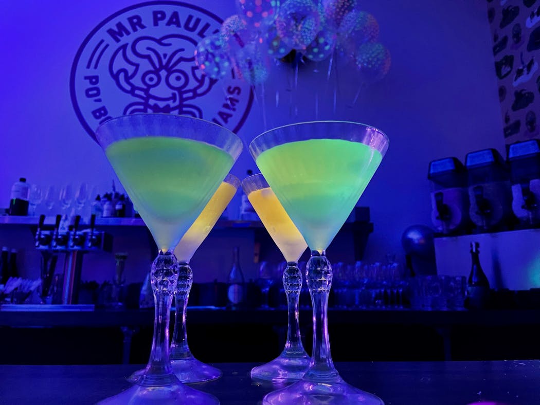 Neon drinks glow on the bar at the Balloon Emporium, a ticketed cocktail tasting dinner weekends at Mr. Paul’s Supper Club in Edina.
