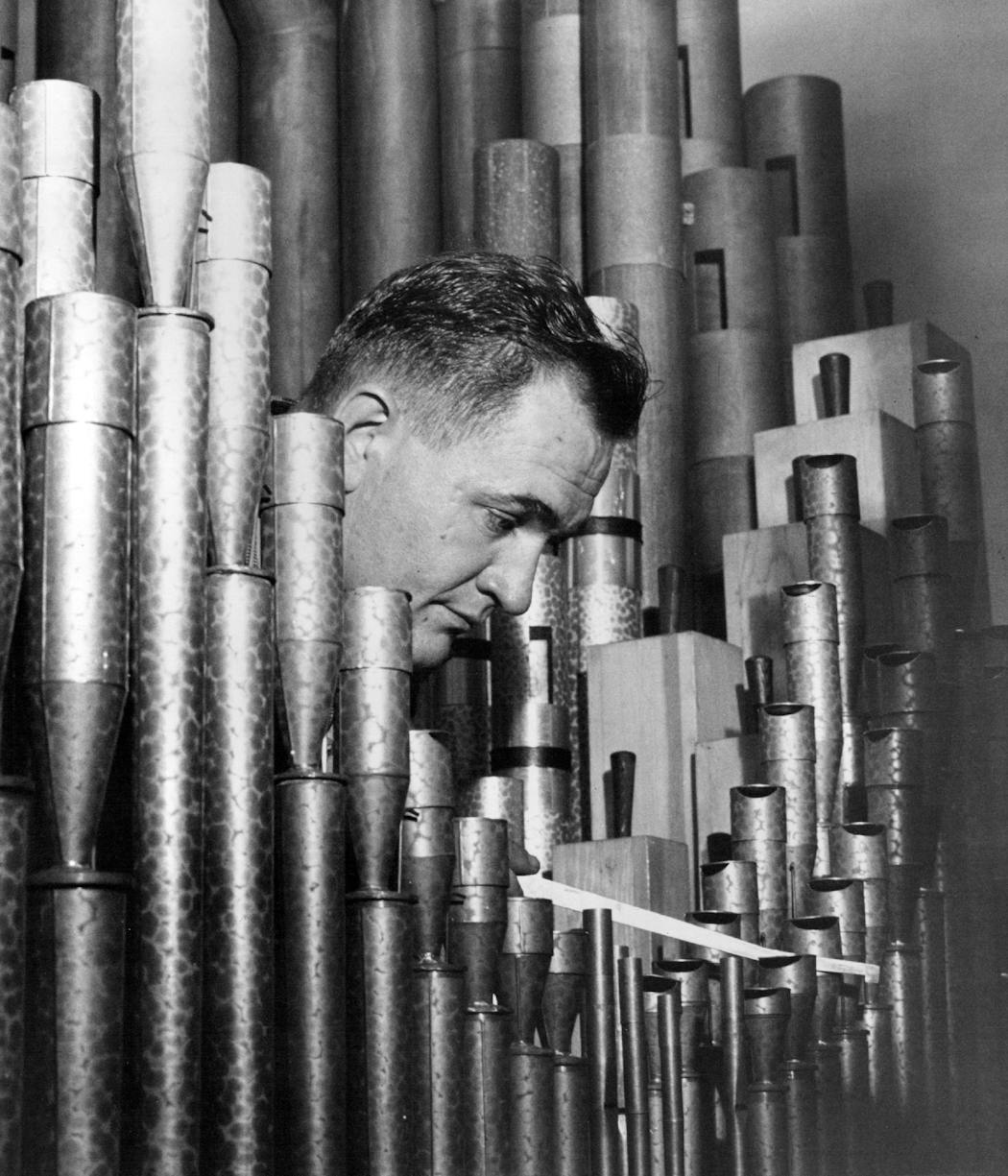 Organ tuner James Milne, Jr. works on some of the organ's 10,000 pipes in 1957.