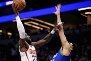 Phoenix Suns center Deandre Ayton (22) shoots against Minnesota Timberwolves center Karl-Anthony Towns on Wednesday.