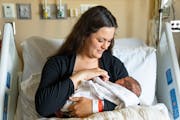 Emily McDonagh holds her newborn daughter, Clare, Thursday at Maple Grove Hospital. North Memorial Health is buying out its partner Fairview Health to