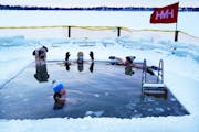 Members of a group know as “The Submergents” soak in icy Lake Harriet in a spot dubbed “Harriet Magic Hole” in January.